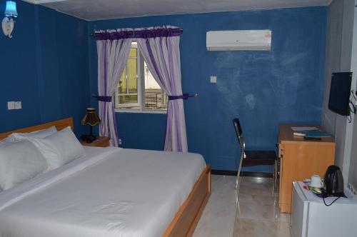 a bedroom with a large bed and a window at Best Connection Airport Hotel in Lagos