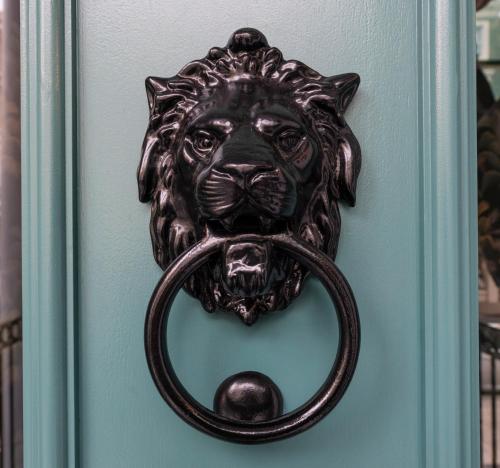 a door knocker of a lion with a ring in its mouth at Brit Hotels Earls Court in London