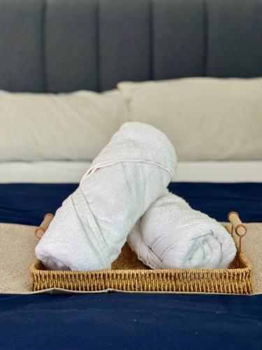 a white sock sitting on top of a bed at AL Rayyan Homestay KLIA SEPANG in Sepang