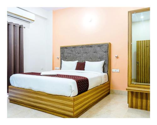 a bedroom with a large bed in a room at Navneeta Grand Near Assi Ghat Full AC Room in Varanasi