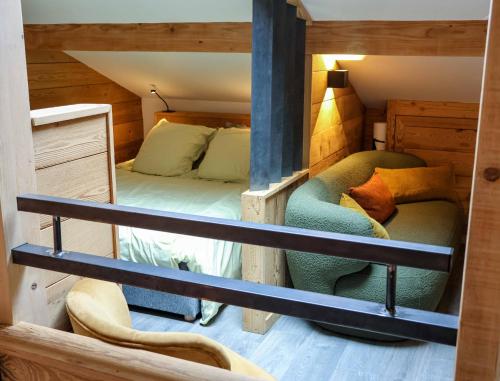 a room with a bunk bed and a couch at Genepi loft duplex 4 personnes in Arâches-la-Frasse