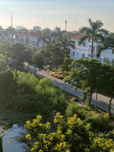 a street with a yellow car driving down a road at Nhật Minh Motel Hải Phòng in Hai Phong