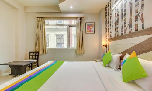 a bedroom with a large bed and a window at Treebo Rockwell Plaza in New Delhi