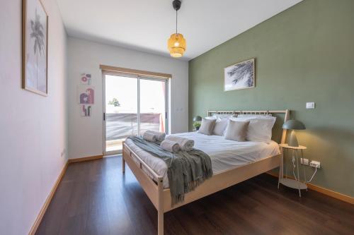 a bedroom with a large bed and a window at Casa A in Olhos de Água