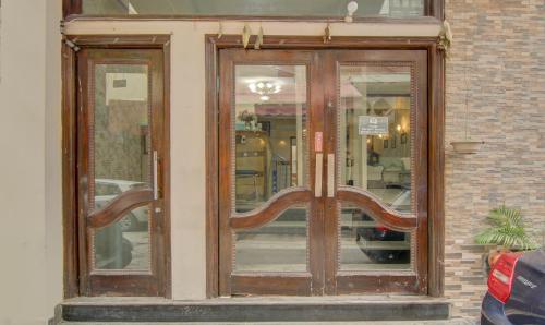 a wooden door to a store with glass windows at Treebo Rockwell Plaza in New Delhi