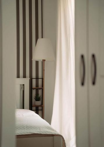 a bedroom with a bed and a lamp and a window at Casa de Manuel in Pinos Genil