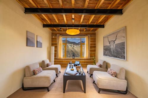 a living room with couches and a table in a room at House on the Clouds, Spiti in Domli