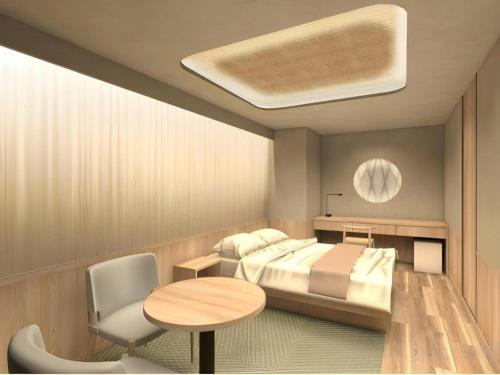 a bedroom with a bed and a table and a chair at Hotel Ann Tsukiji in Tokyo