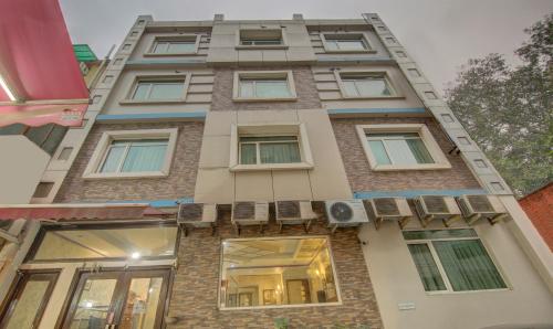 a tall brick building with windows and a balcony at Treebo Rockwell Plaza in New Delhi