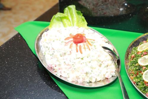 a salad with a spider on top of it on a table at Al Jazeera Royal Hotel in Abu Dhabi