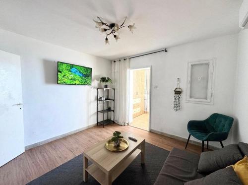 a living room with a couch and a table at Seaside Vacation in Haifa