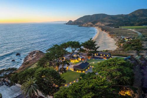 an aerial view of a house next to the ocean at Distinguished Oceanfront Point Estate with Iconic Beach Mountain Vistas in Montara