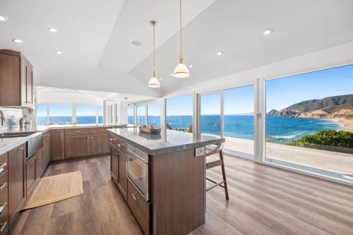 a kitchen with a view of the ocean at Distinguished Oceanfront Point Estate with Iconic Beach Mountain Vistas in Montara