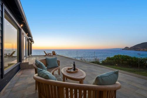 a patio with a view of the ocean at Distinguished Oceanfront Point Estate with Iconic Beach Mountain Vistas in Montara