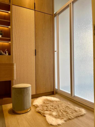 a room with a furry rug and a large window at The Horizon Ipoh By Iconique Espace in Ipoh