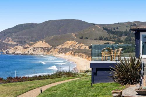 a house with a view of a beach at Distinguished Oceanfront Point Estate with Iconic Beach Mountain Vistas in Montara