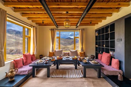 a living room with a couch and a table at House on the Clouds, Spiti in Domli