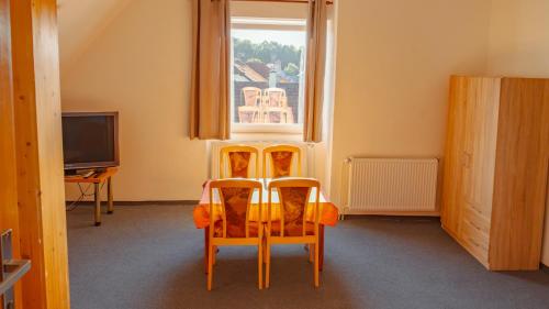two chairs sitting in a room with a window at Vila Familia in Turčianske Teplice