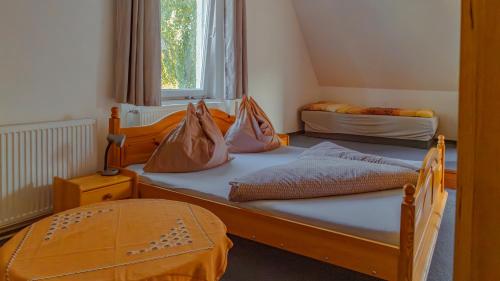 two beds in a room with two bags on them at Vila Familia in Turčianske Teplice