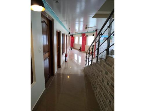a hallway of a building with a person walking down it at Hotel Guru International Andaman in Aberdeen