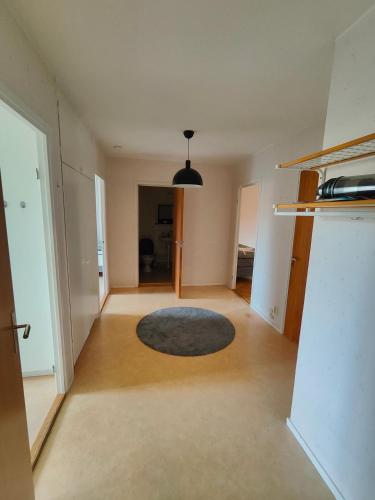 an empty living room with a rug on the floor at Katrineholm Longstay - Fully equipped 3 room apartment in central Katrineholm in Katrineholm
