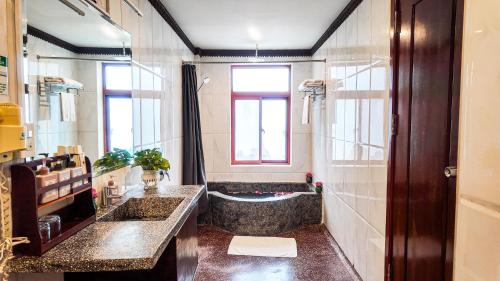 a bathroom with two sinks and a bath tub at Okay Boutique Hotel in Phnom Penh