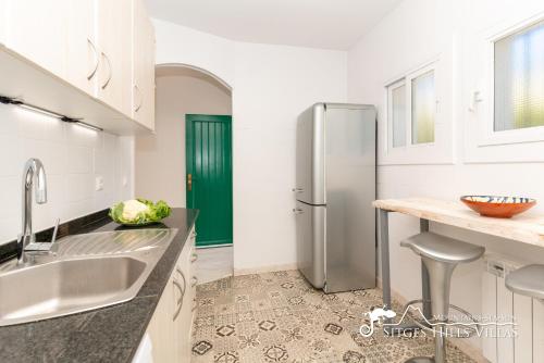 eine Küche mit Kühlschrank und Spüle in der Unterkunft Casa Sian Retreat near Sitges in Olivella