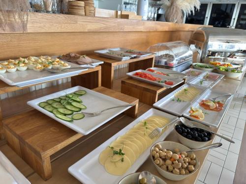 a buffet with several plates of food on display at Hotel Zhong Hua in Sopot