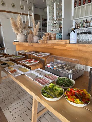 a buffet with many plates of food on a table at Hotel Zhong Hua in Sopot