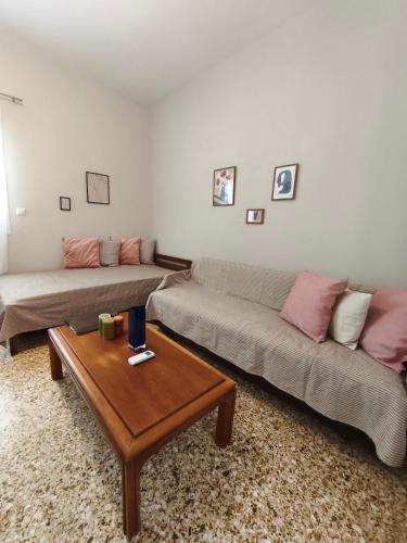 a living room with two couches and a coffee table at Flya House in Athens