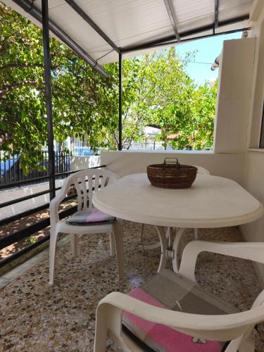 a white table and chairs on a patio at Flya House in Athens