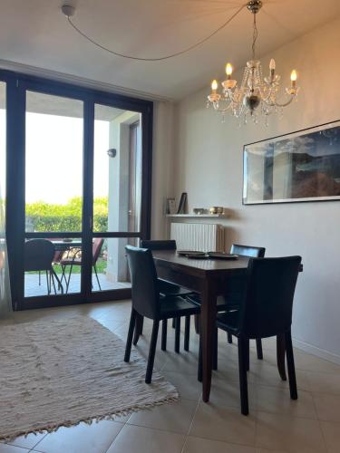 a dining room with a table and chairs and a chandelier at Chez Francois Lazise Pool in Lazise
