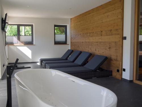 a bathroom with a couch and a bath tub at Chalet Wachterfeld in Berchtesgaden
