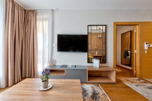 a living room with a tv on the wall at Mountain Pearl Zlatibor in Zlatibor