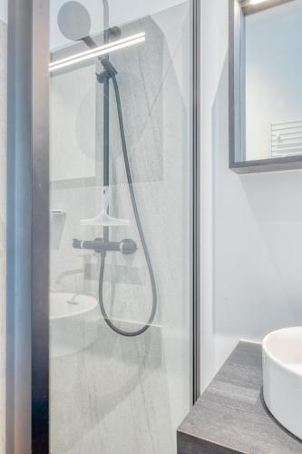 a shower in a bathroom with a sink at 4 Beautiful Apartments in the Center of Ieper in Ypres