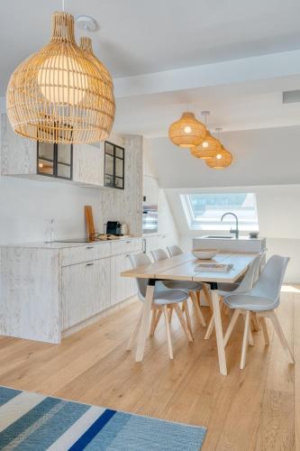 a kitchen with a table and chairs and a sink at 4 Beautiful Apartments in the Center of Ieper in Ypres