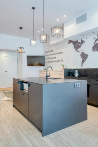 a kitchen with a sink and a counter top at 4 Beautiful Apartments in the Center of Ieper in Ypres