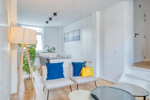 a living room with two chairs and a sink at 4 Beautiful Apartments in the Center of Ieper in Ypres