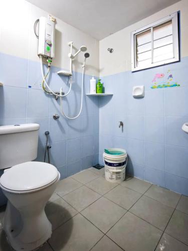 a bathroom with a toilet and a shower at Sekinchan 231 VA Chalet in Sekinchan