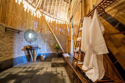 a large room with wooden walls and a wooden ceiling at Velonia Iseh in Sidemen