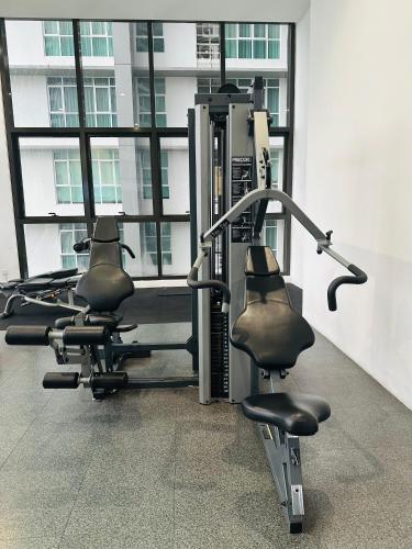 a gym with two exercise bikes in a building at KL suites by Nomad in Kuala Lumpur