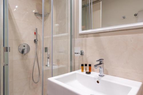 a bathroom with a sink and a shower at Excelsior Palace Hotel in Taormina