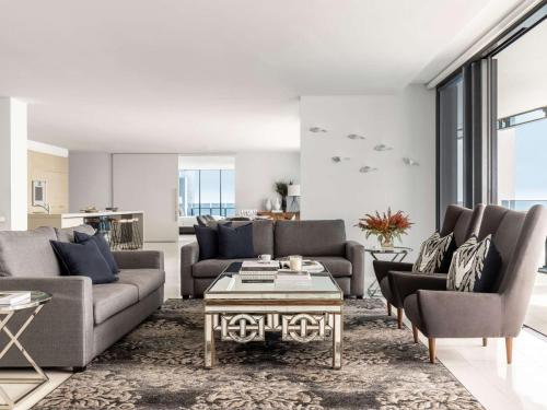 a living room with two couches and a coffee table at Peppers Soul Surfers Paradise in Gold Coast