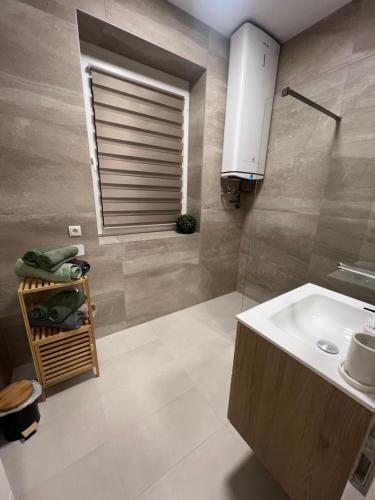 a bathroom with a sink and a window at Apartment Sofia Nähe Redbull Ring in Knittelfeld