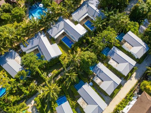 an overhead view of a building with palm trees at Bougain Villas in Salad Beach