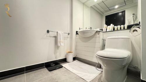 a bathroom with a white toilet and a sink at Al Reef Luxury Studio - Elegant Stay Near Al Reef Community Park in Abu Dhabi
