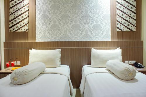 Ένα ή περισσότερα κρεβάτια σε δωμάτιο στο Nevada Ketapang Hotel