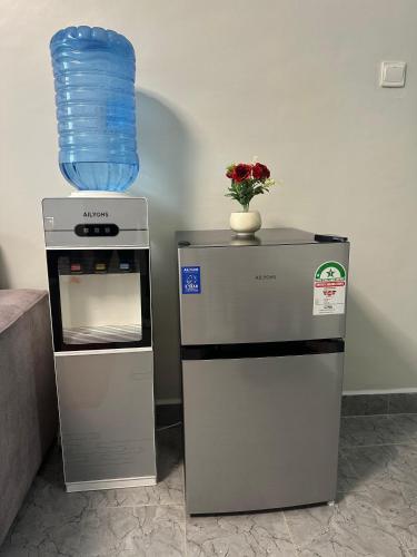 a vase of flowers sitting on top of a refrigerator at Ecostay Economy 2bed424 in Kisumu