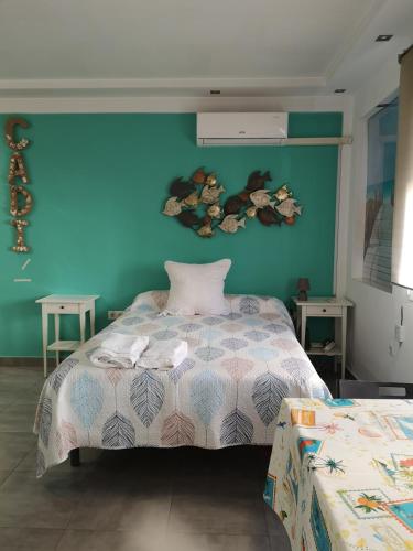 a bedroom with a bed and a blue wall at El rincon de la playita VFT/CA /03874 in Cádiz