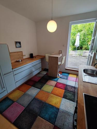 a kitchen with a colorful rug on the floor at Altbau-Traum mit Riesen-Dachterrasse in Moosburg